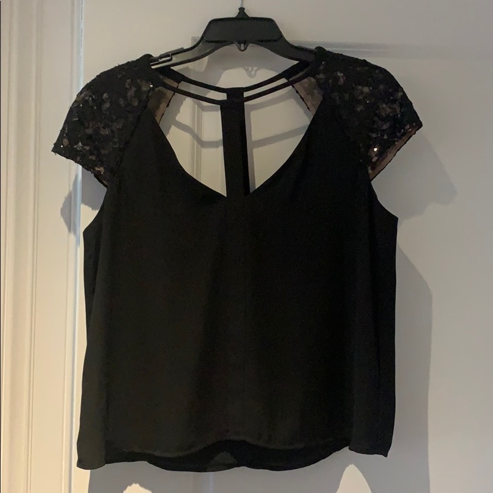 Black top with cap sleeve embellishment